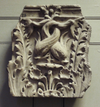 Fragment of a Roman composite pilaster capital carved with acanthus leaves and a pair of dolphins 