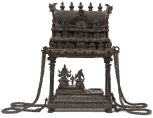 Model of a South Indian temple with a group of figures beneath the temple roof: the God Shiva, his consort Parvati and their son Skanda (or Kartikeya)