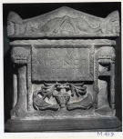 A Roman funerary urn (cinerarium) with separate lid, its name plate flanked by tripods. 