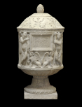 Round cinerary urn carved with genii and sphinxes. 