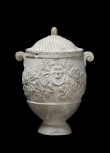 Cinerary vase carved with bacchanalian heads and vine leaves