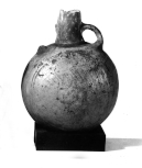 A Peruvian vessel with two handles (one broken)