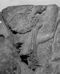 Fragment of a cresting plaque from the ridge of a Roman roof: a woman walking towards a candelabrum