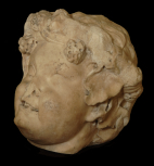 Fragment of a decorative oscillum ('little face') relief or panel 