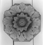 Cast of an unidentified antique rosette mounted on an octagonal backboard