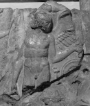Fragment of a cresting plaque from the ridge of a Roman roof: Eros standing amongst stylised acanthus foliage and vine tendrils