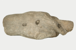 A fragment of a Roman statue: a colossal male right hand holding a rolled scroll 