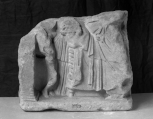 The lower left-hand section of a Greek sepulchral or votive relief 