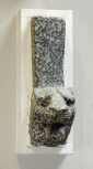 Fragmentary top section of a piece of Roman furniture consisting of the head of lion behind which rises an unusually high, heavy rectangular support, probably in this case part of a table leg