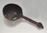 A Roman utensil handle attached to a perforated brass bowl