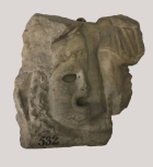 Fragment of a Roman sarcophagus front with a medallion mask and figure of Eros. 