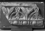 Fragment of Roman interior decoration: the top member of an architrave or door panel, consisting of fillet above cyma reversa enriched with alternate triple bay leaves and hollowed, reversed, waterleaf  with foliage inside, all highly stylised; and with a bead and reel moulding below.