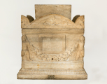 Roman garlanded funerary urn (cinerarium) with genii figures at the front corners and a separate lid 