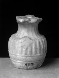 Fragment of decorative carving in the form of a small vase(?)